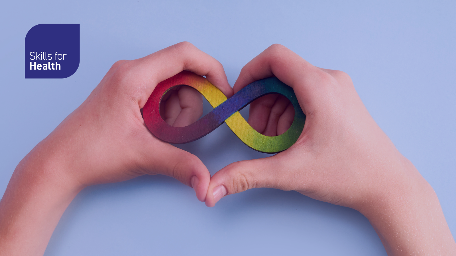 Two hands making a heart shape with the rainbow infinity logo