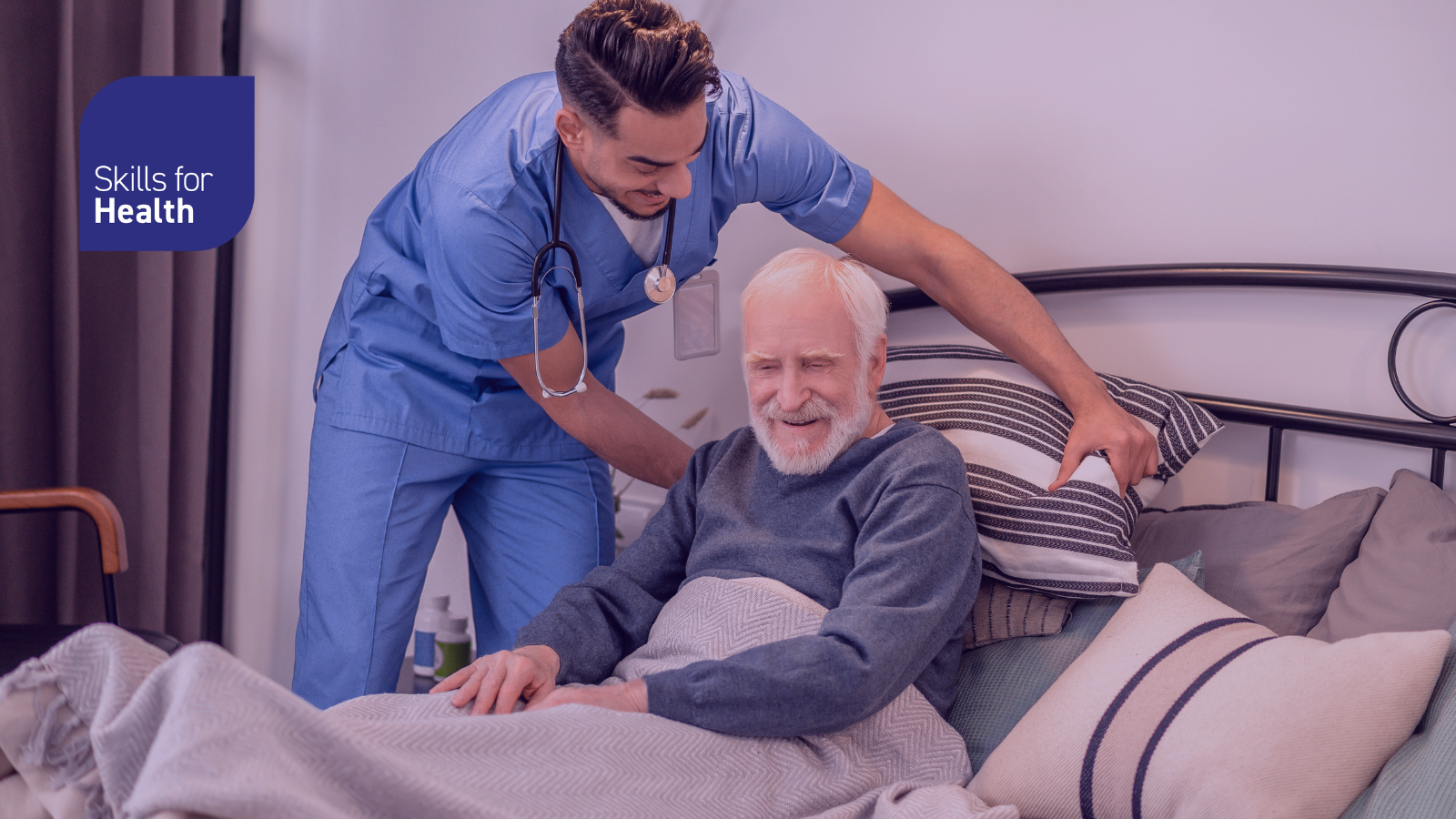 Nurse helping elderly man in bed