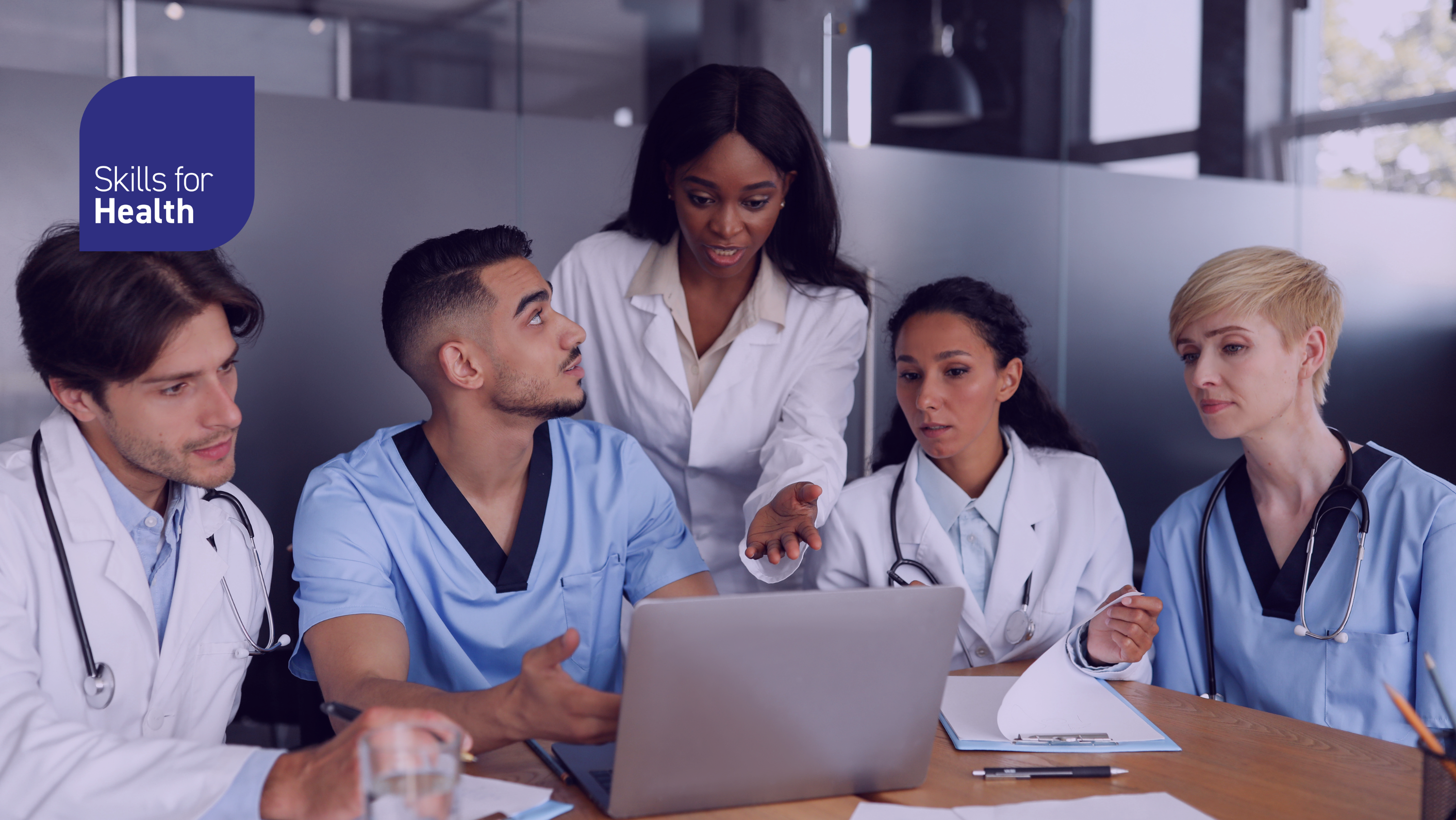 Doctors grouped around laptop