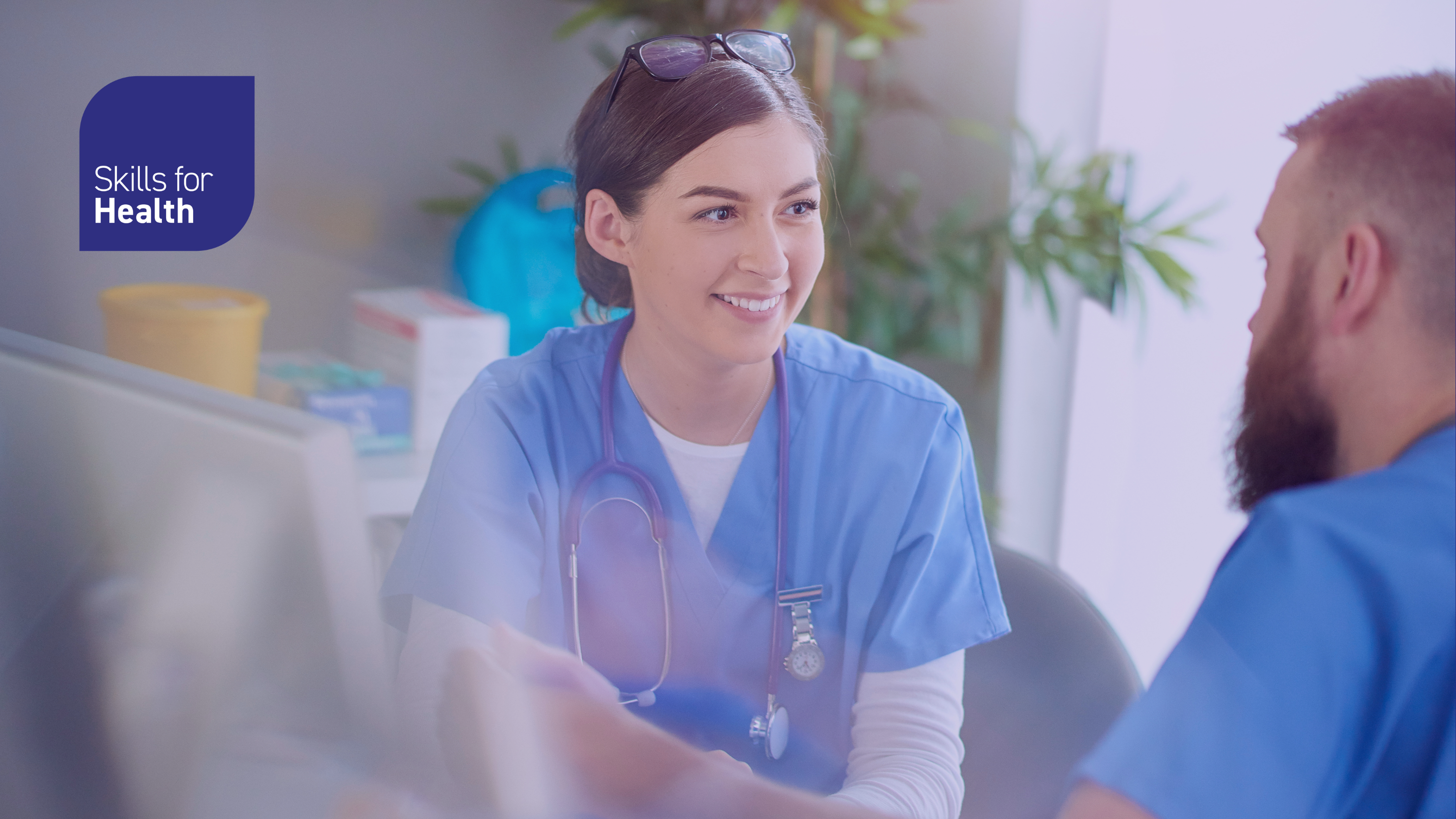 Healthcare staff in conversation with each other, smiling and engaging