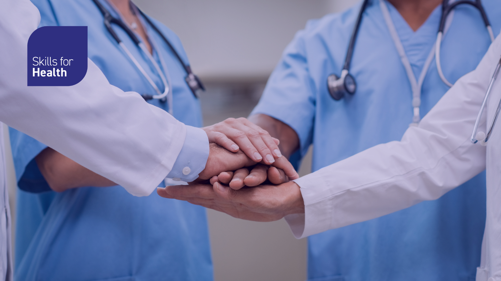 Healthcare staff putting hands in circle